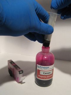 Draw off the ink you need into your syringe being careful not to knock over the bottle of ink
